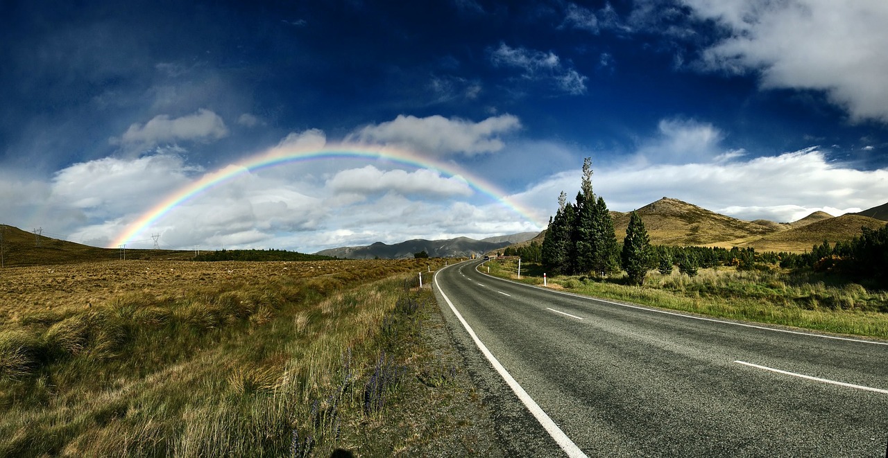 road leading to a rainbow